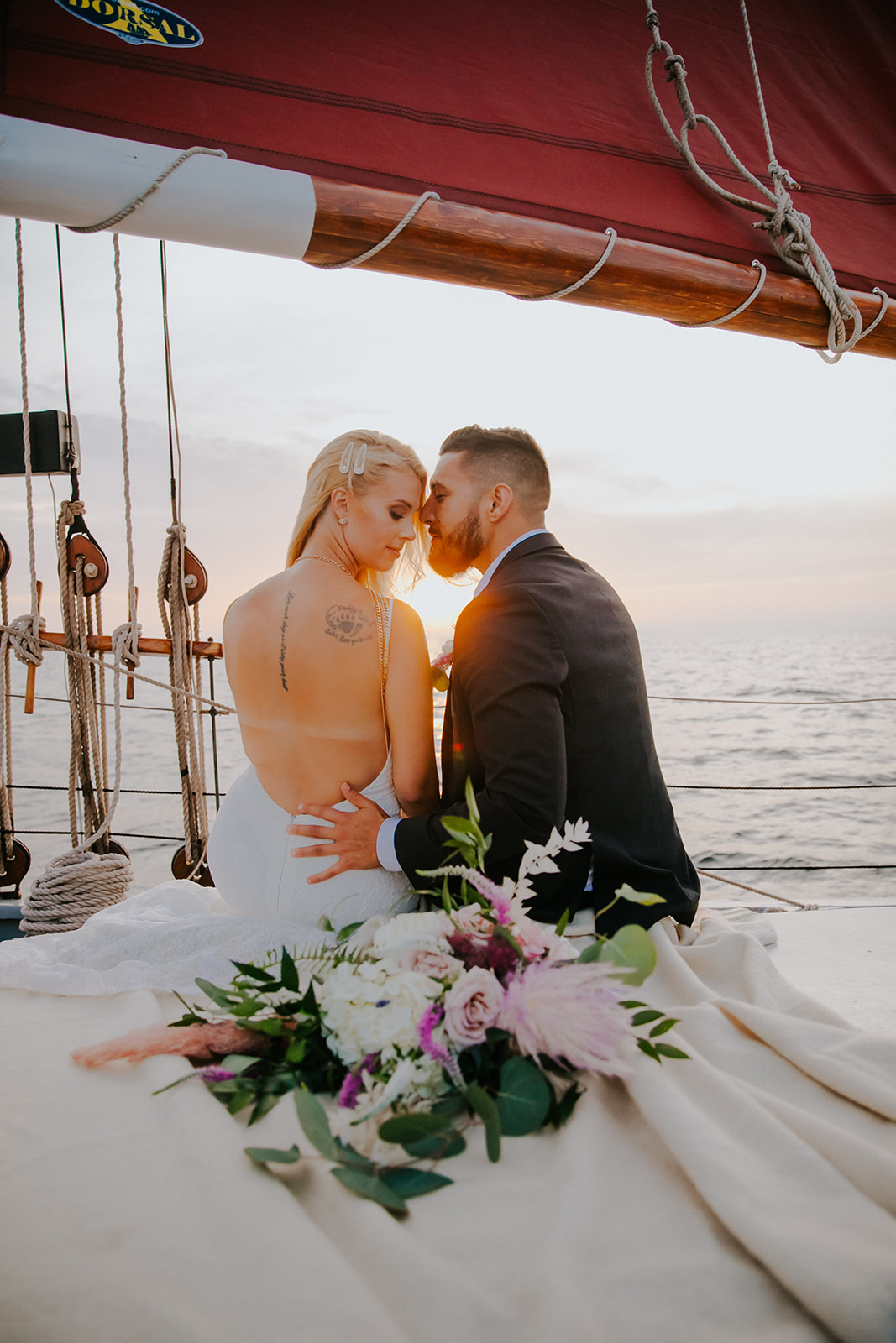 Bride and groom nuzzle into each other on Sail Door County
