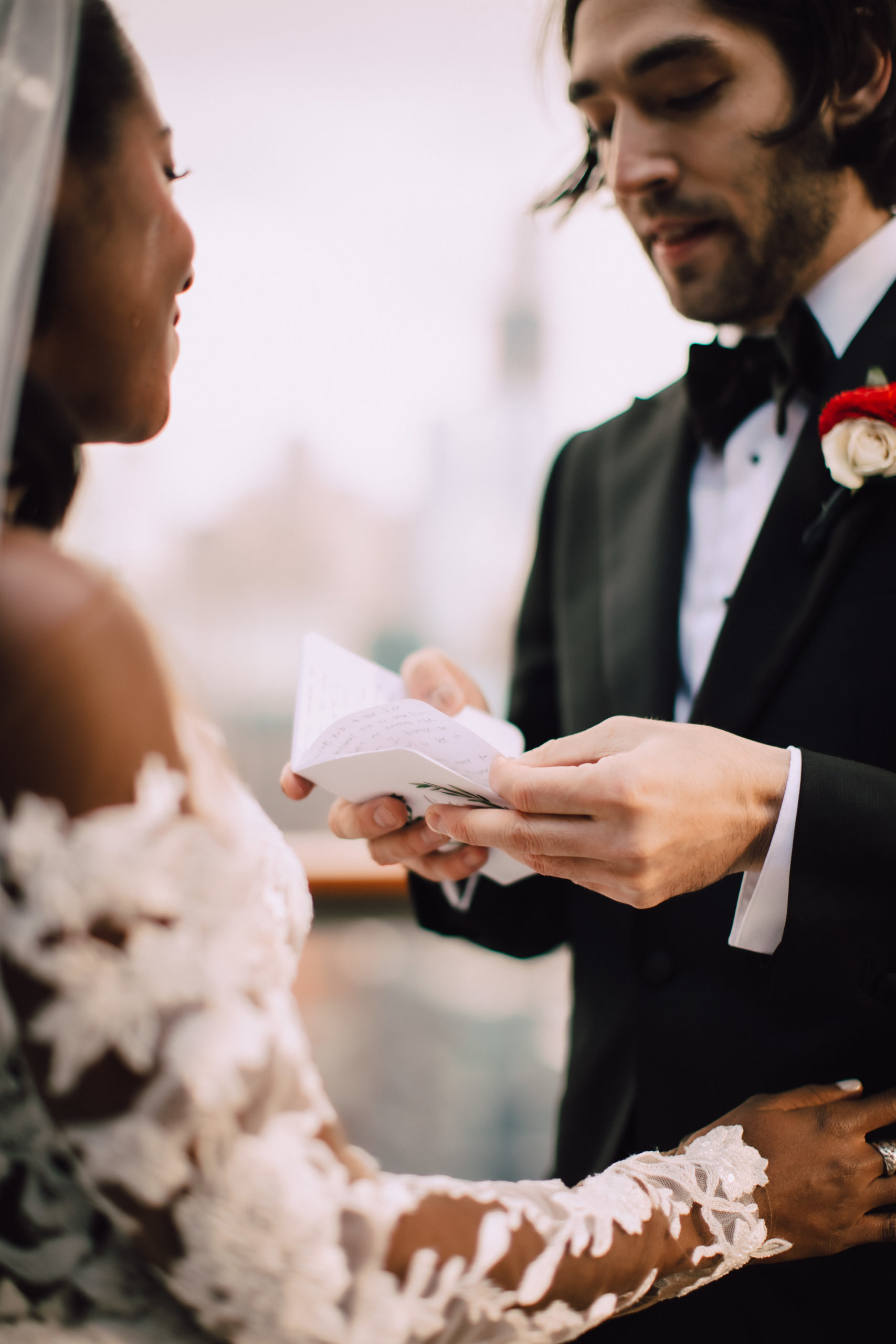 Groom holds vow book