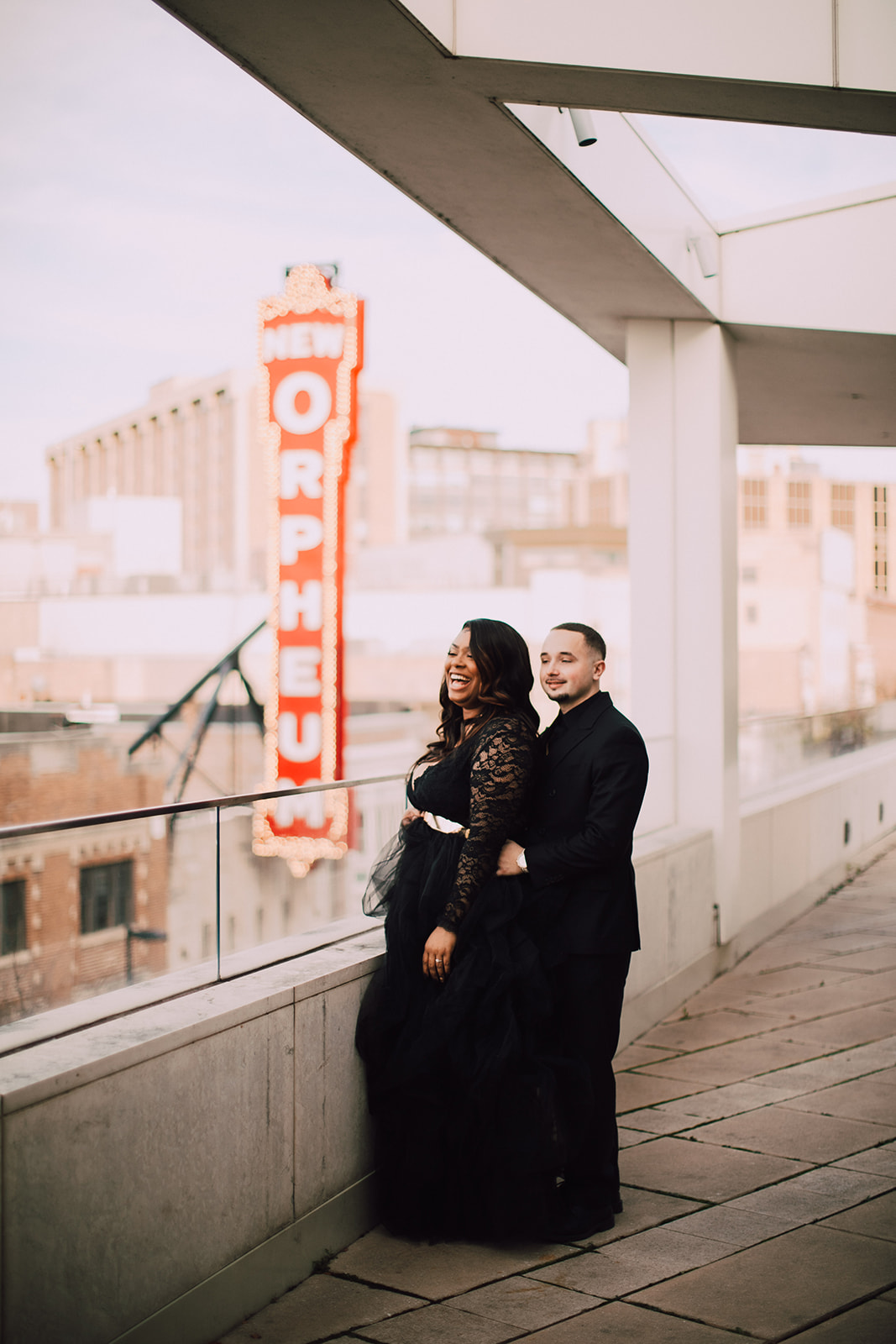 A couple shares a candid moment together on MMoCA rooftop. Engagement photos captured by Madison wedding photographer O & B Photo Co